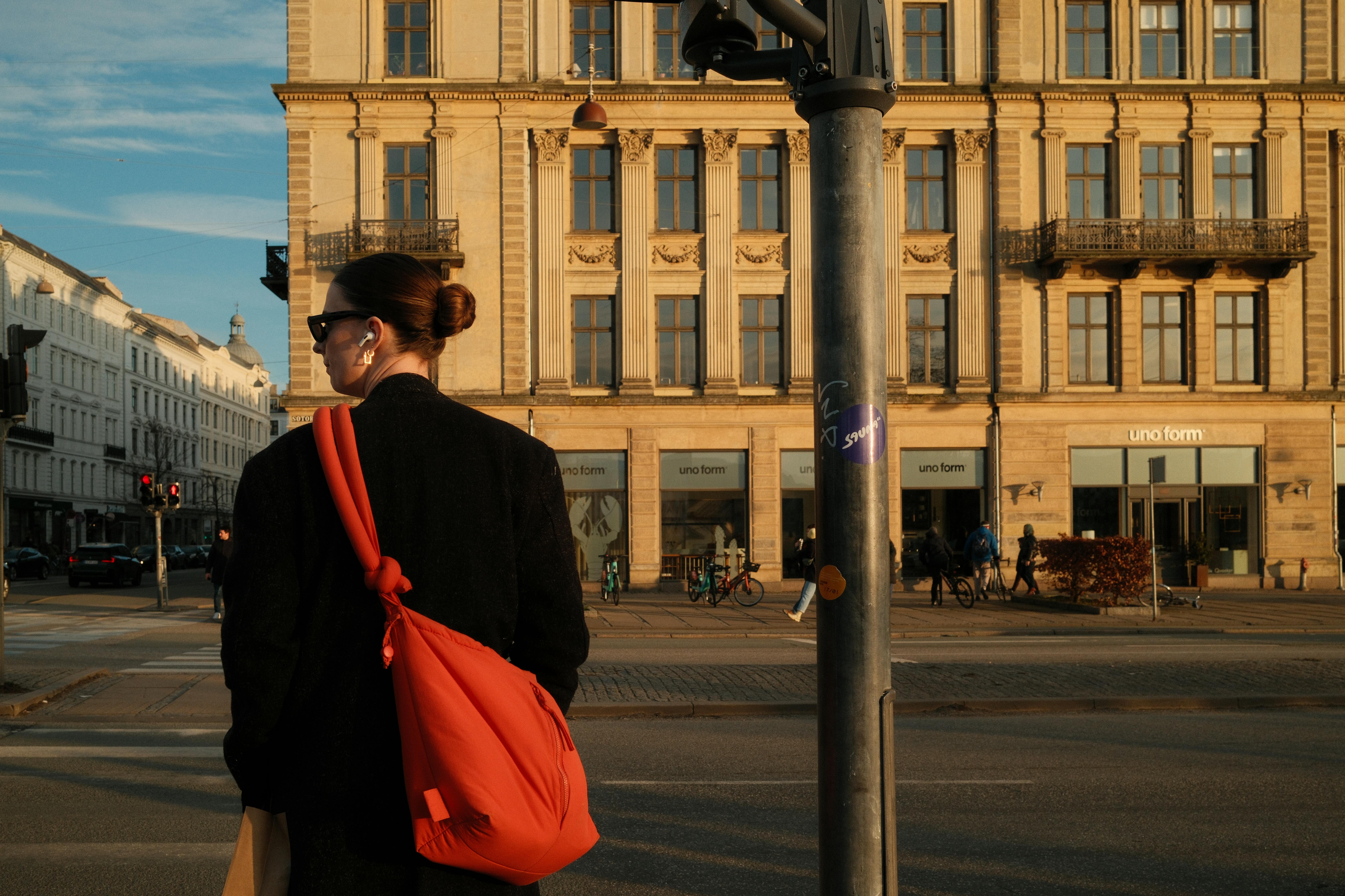 Person walking outdoors with earbuds
