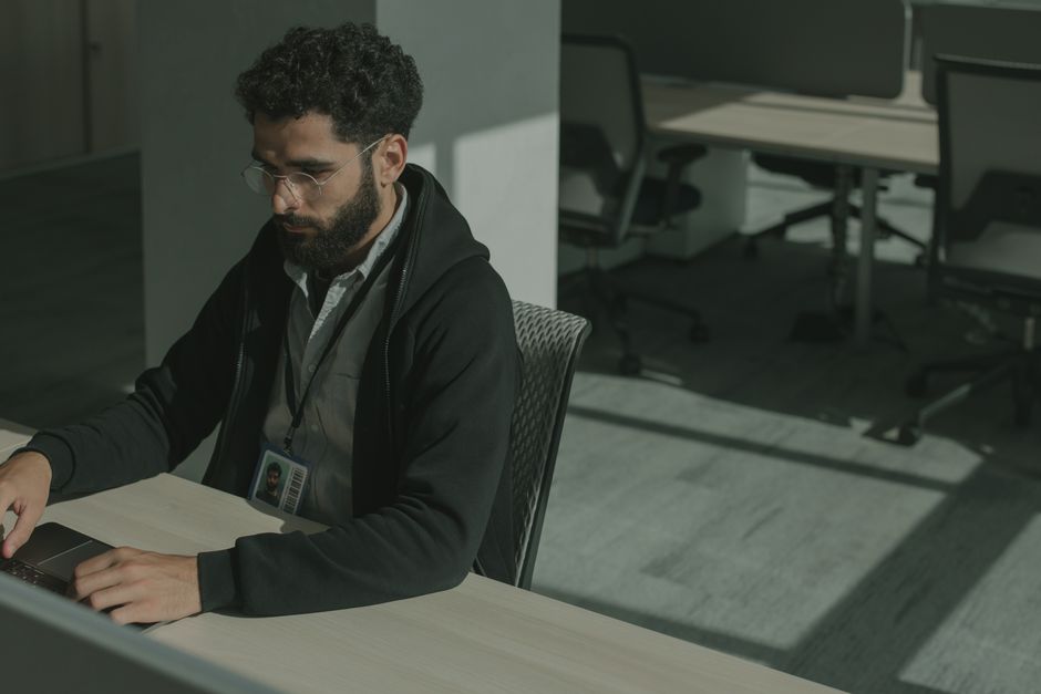 Engineer rereading a dense technical document on a laptop