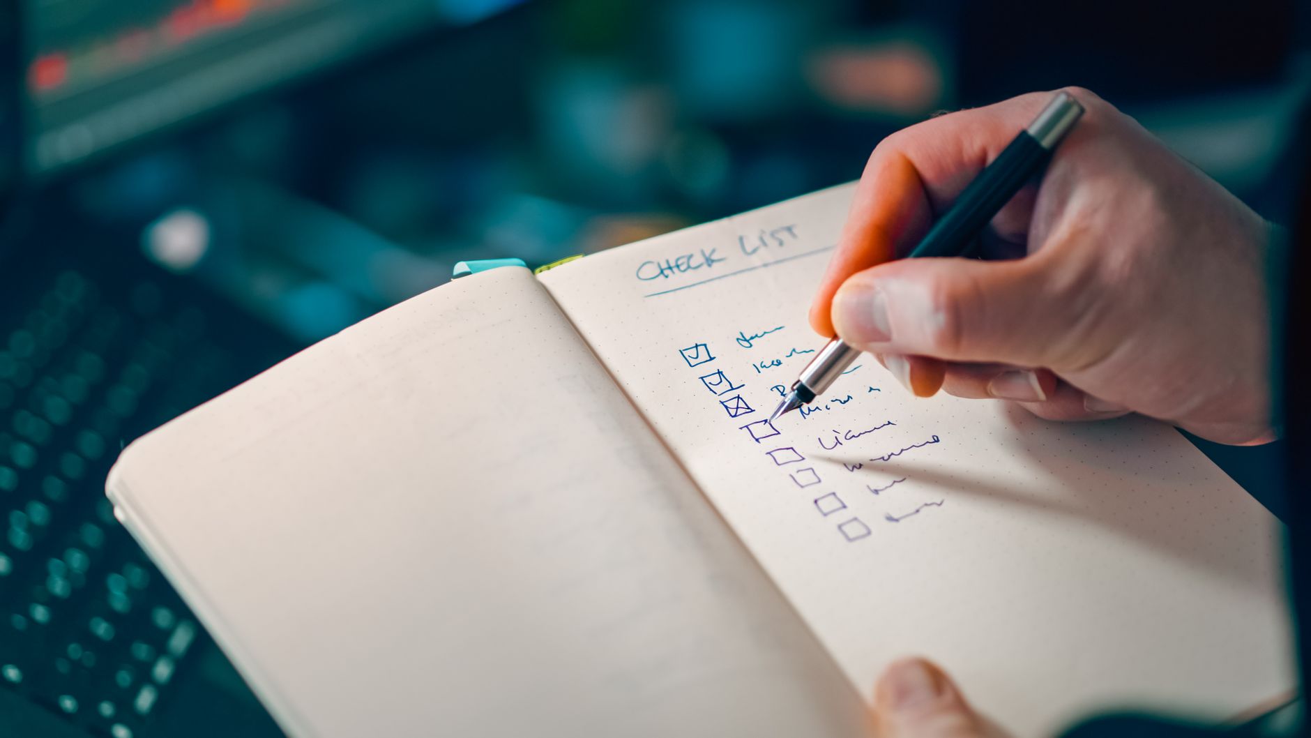 A handwritten log of items with checkmarks in a notebook