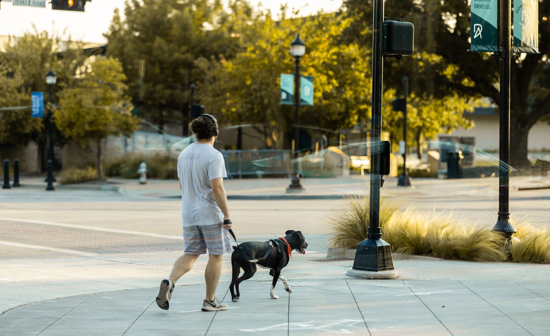 A person walking outdoors wearing headphones